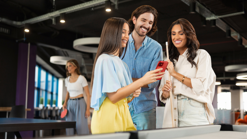 Arrise employees looking at a phone